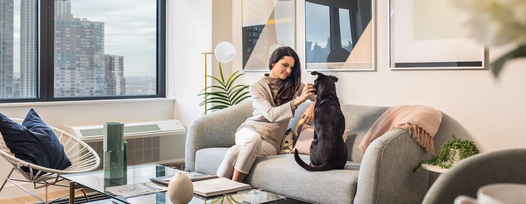 a woman and a dog sitting on a couch