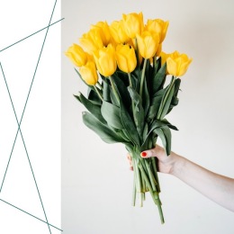 a person holding a bouquet of yellow flowers