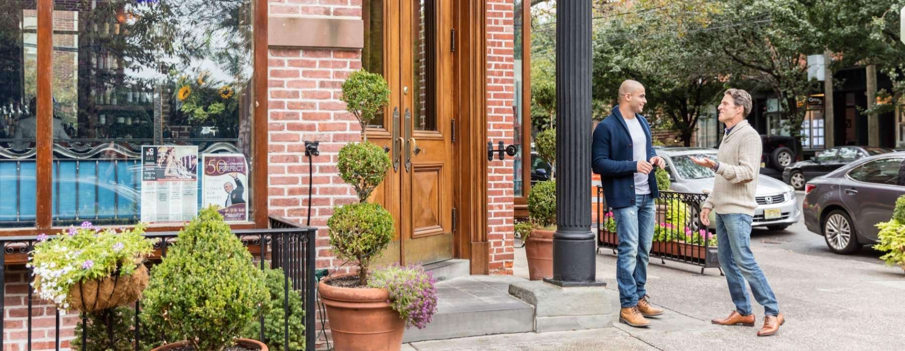 a man and woman sitting outside a building