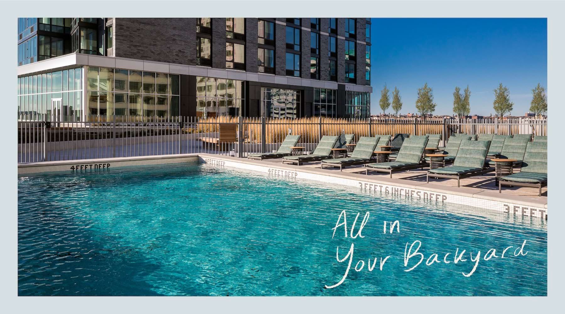a swimming pool with lounge chairs