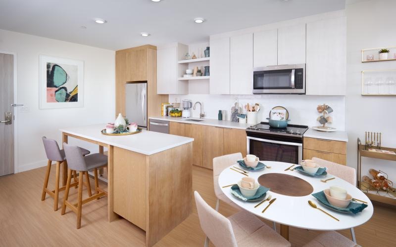 a kitchen with a dining table and chairs
